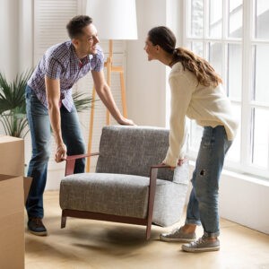 Couple carrying chair together | Hernandez Wholesale Flooring