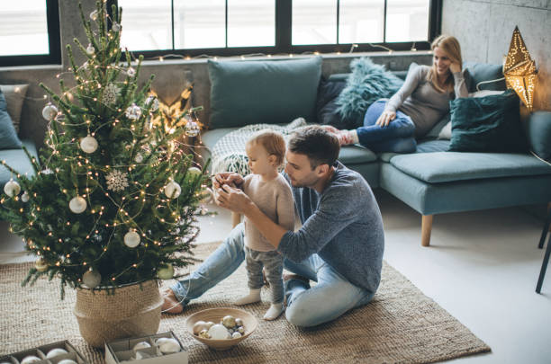 Father and daughter decorate a christmas tree | Hernandez Wholesale Flooring